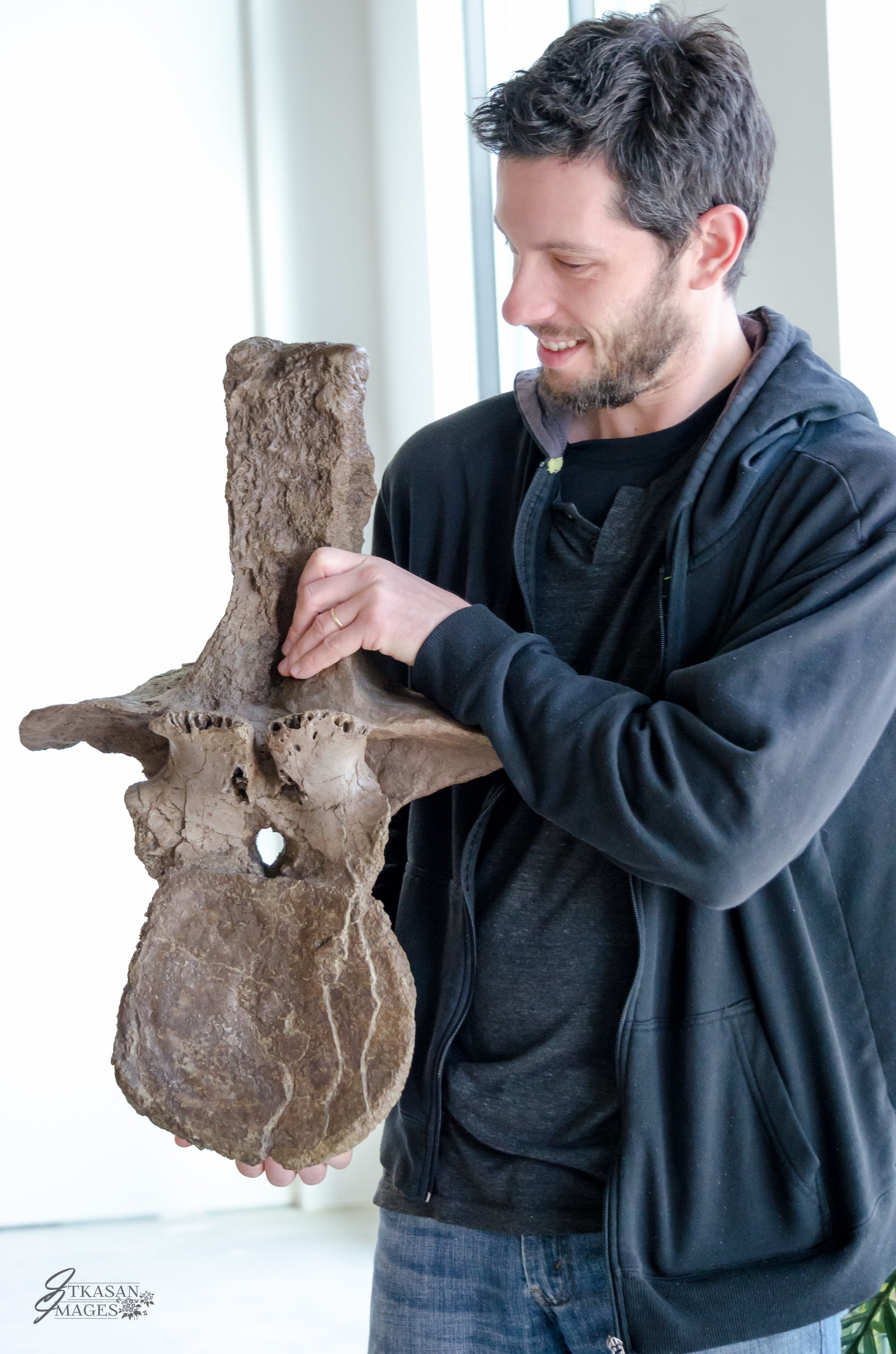Tyrannosaurus rex - skull  One of our visitors holding a T.rex dorsal vertebrae.    (approx. 65 million years old)    Photo credit: Itkasan Images, Victoria BC