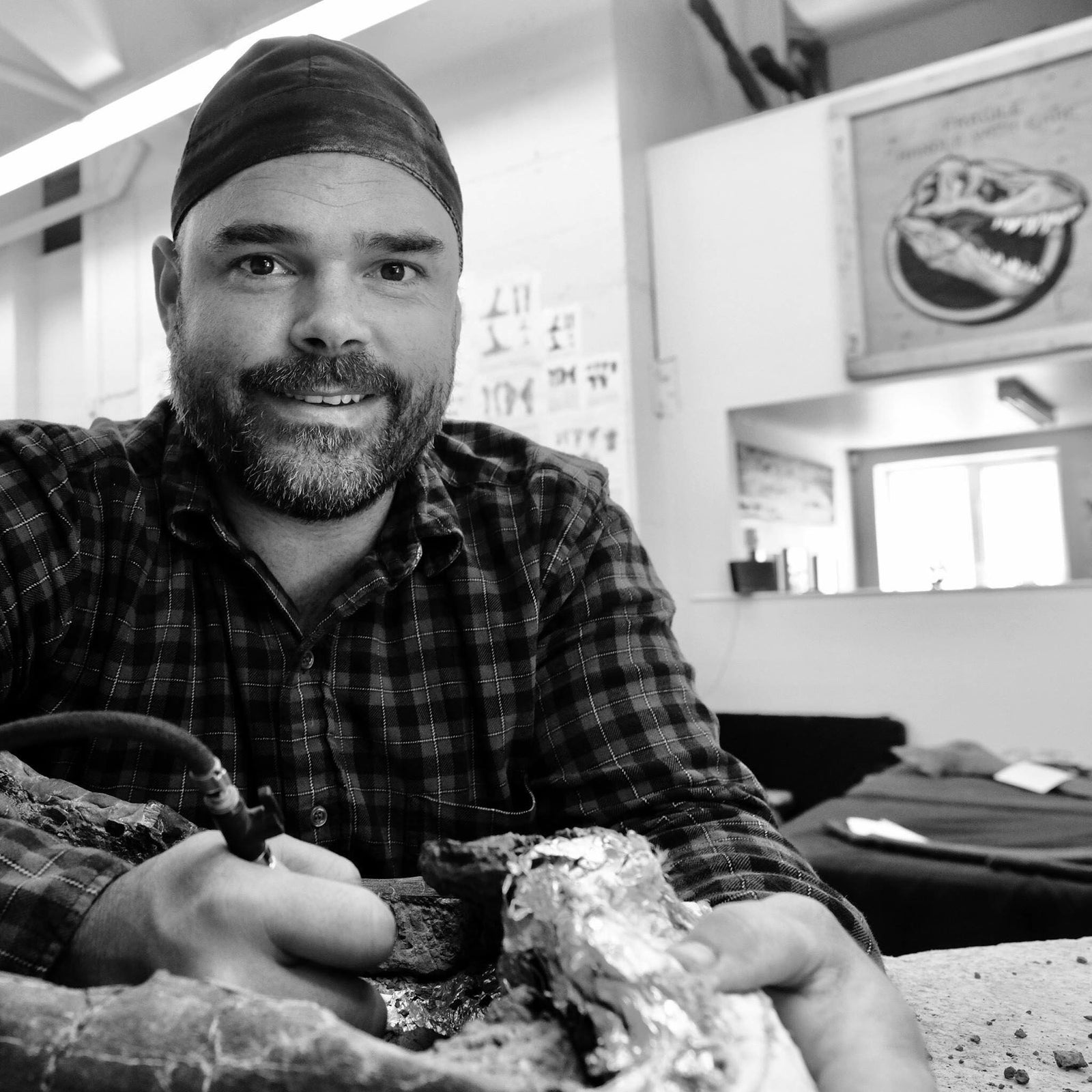 Fossil Prep in Action  Just a boy, working on a dinosaur asking it to love him.